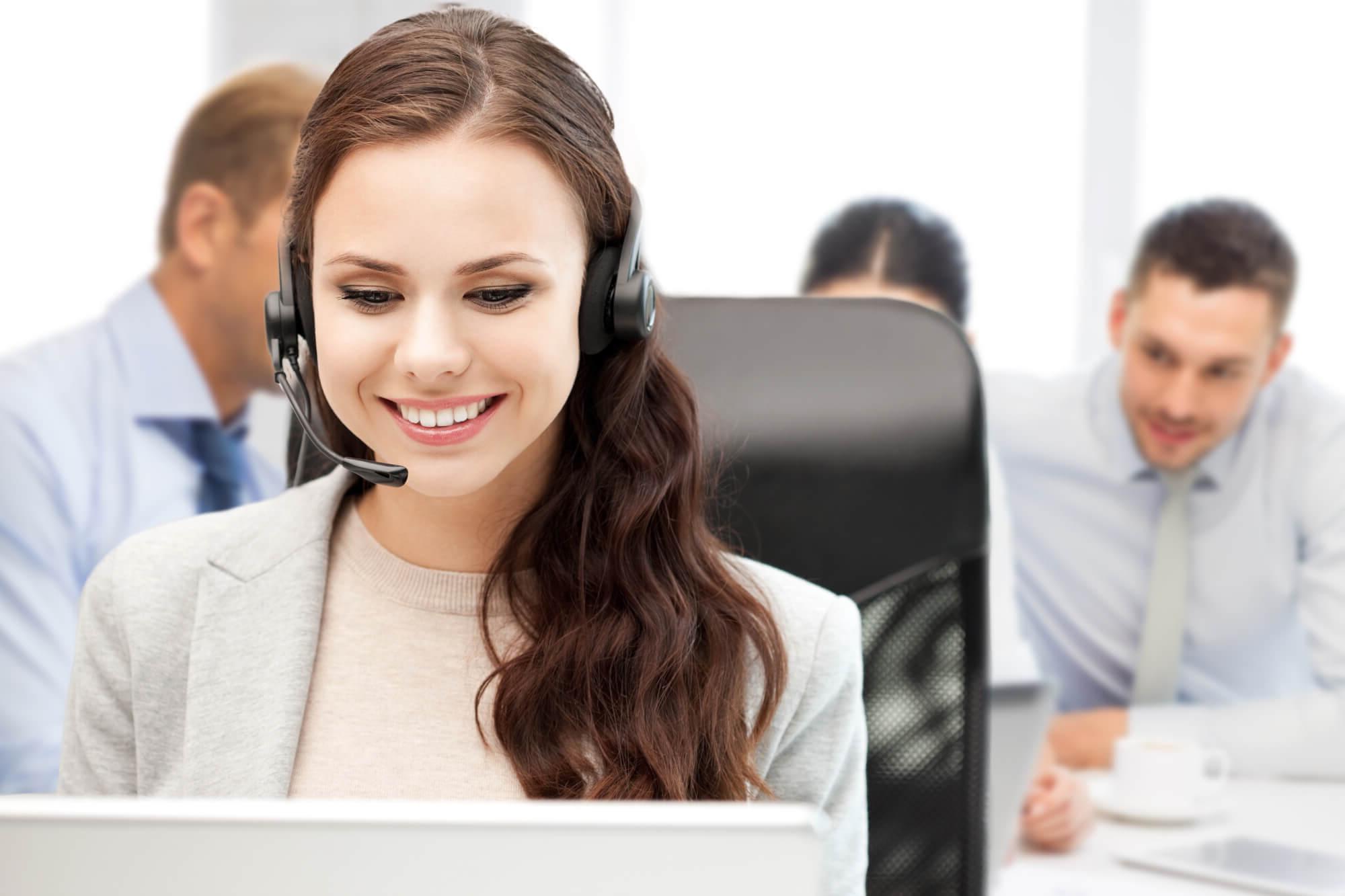 Woman in call center wearing VoIP headset
